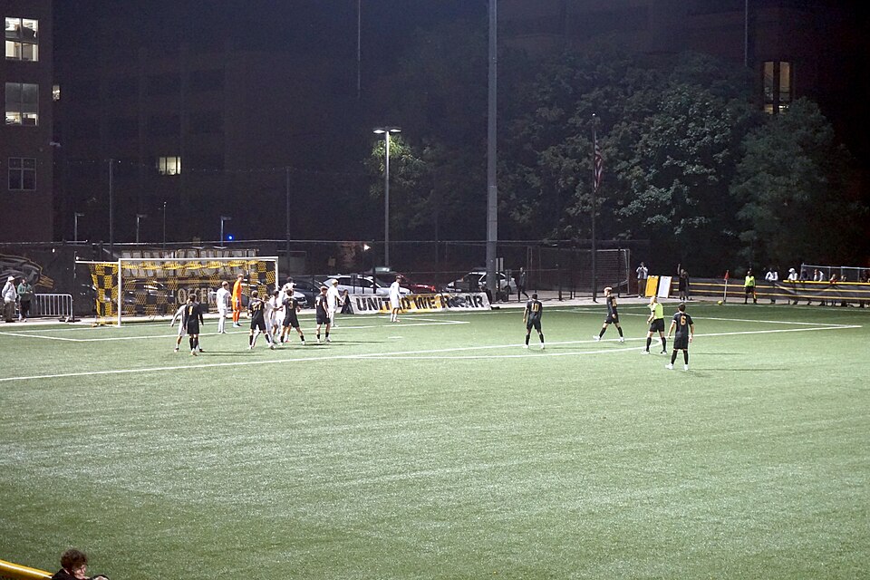 Jugador ejecutando un tiro de esquina durante un partido de fútbol